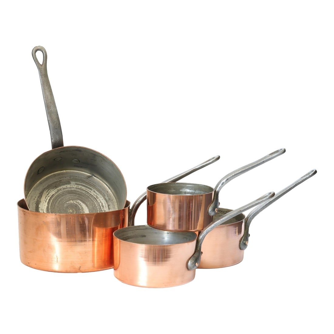 Graduated Set of Antique French Copper Saucepans with Iron Handles: A handsome graduated set of antique French copper saucepans, crafted from thick-gauge copper with riveted iron handles for strength, balance, and longevity. The softly curved forms and substantial
