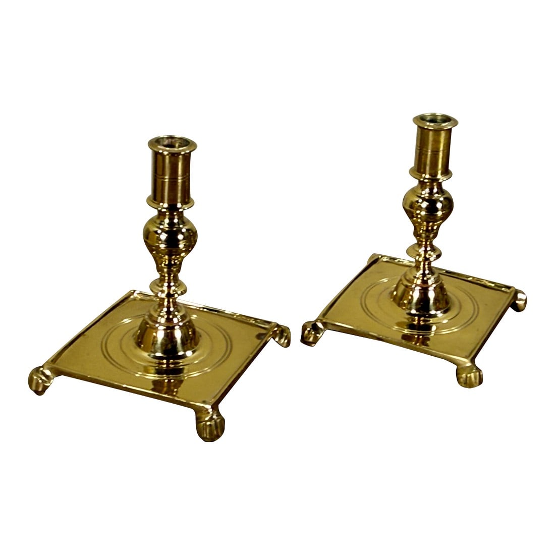 Vintage Virginia Metalcrafters Brass Candlesticks for Colonial Williamsburg - A Pair: This pair of solid brass candlesticks was manufactured by Virginia Metalcrafters for Colonial Williamsburg. The candlesticks feature traditional colonial styling with square bases set on ball feet,