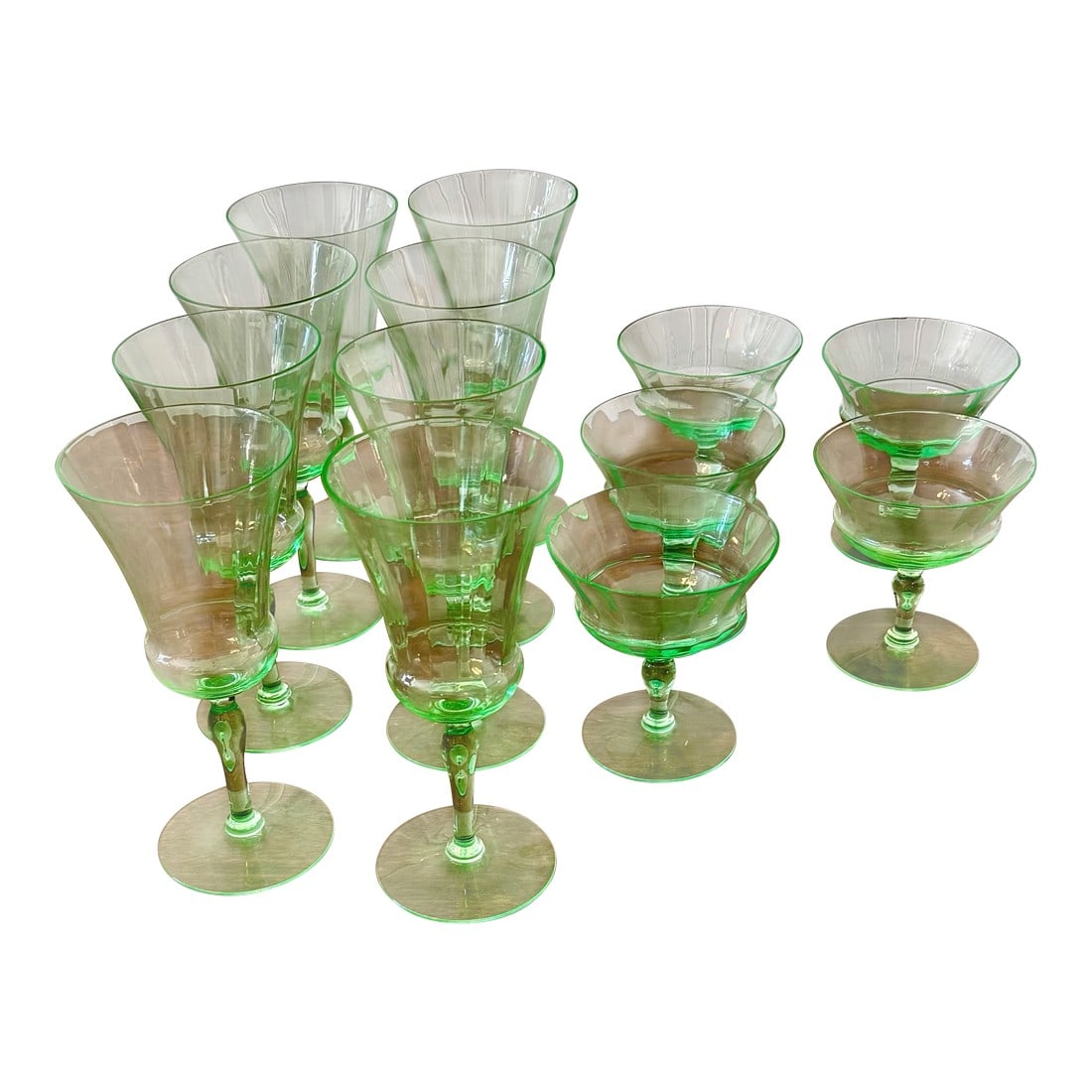 Early 20th Century Uranium Vaseline Glass Cambodia Stemware by Utility Glass Works - Set of 13: This set of Vaseline Barware consists of eight cordial wine glasses and five champagne coupes manufactured by Utility Glass Works in the depression era (early to mid-20th century). The Cambodia patter