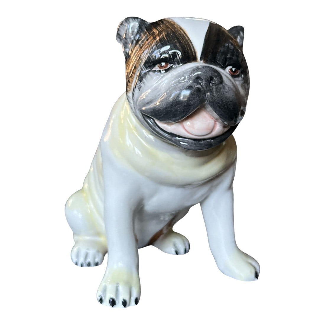 Mid 20th Century Staffordshire Porcelain Pug Hand-Painted English Charm: A wonderfully expressive Staffordshire porcelain pug, capturing the endearing personality and stout elegance that have made the breed a favorite for centuries. This seated pug features beautifully han