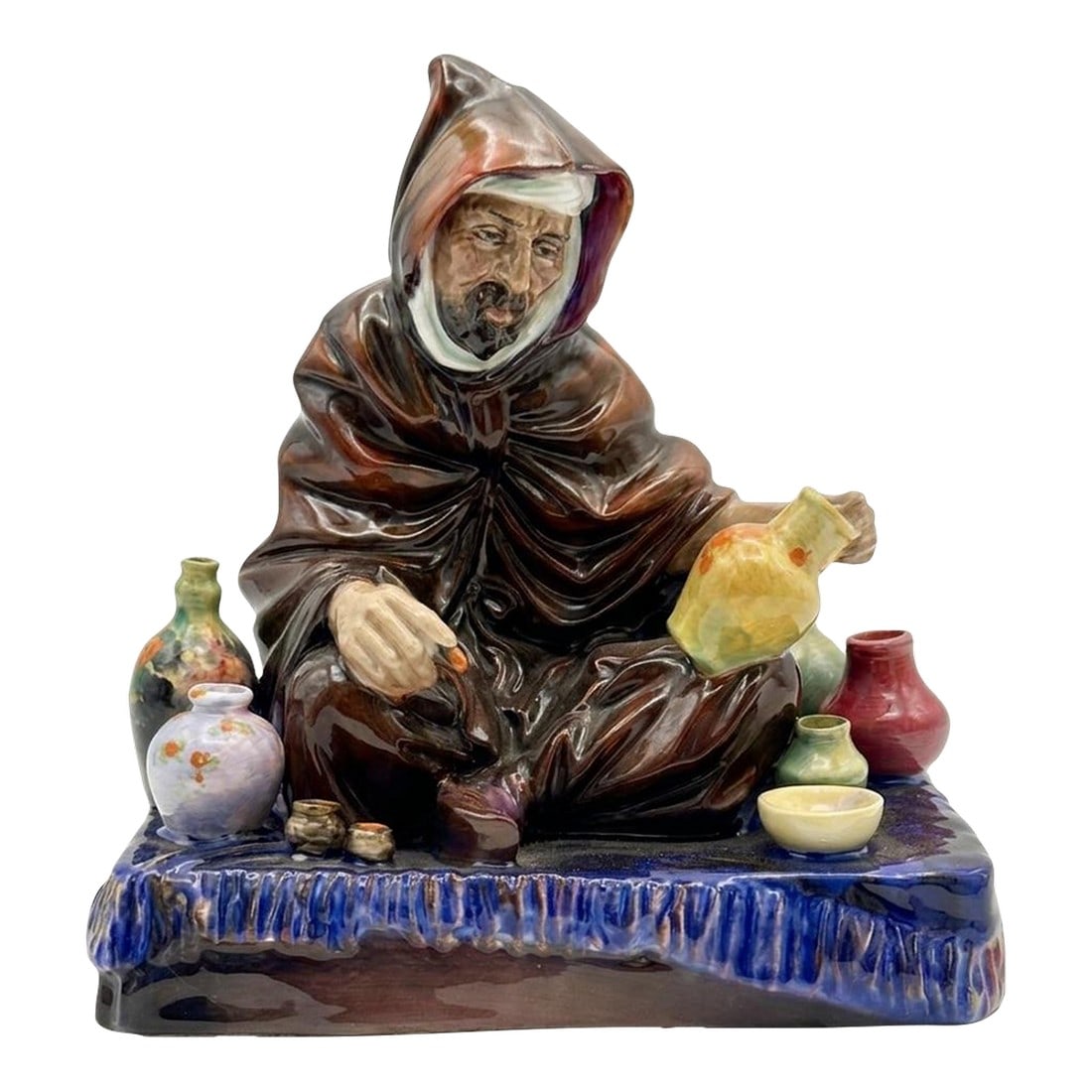 Mid-Century Royal Doulton "The Potter" Figurine Hn 1493 - Vintage Original by Charles: A soulful tribute to the ancient art of ceramics, "The Potter" (HN 1493) is a masterwork of mid-century English porcelain. Designed by the celebrated Charles Noke for Royal Doulton, this figurine
