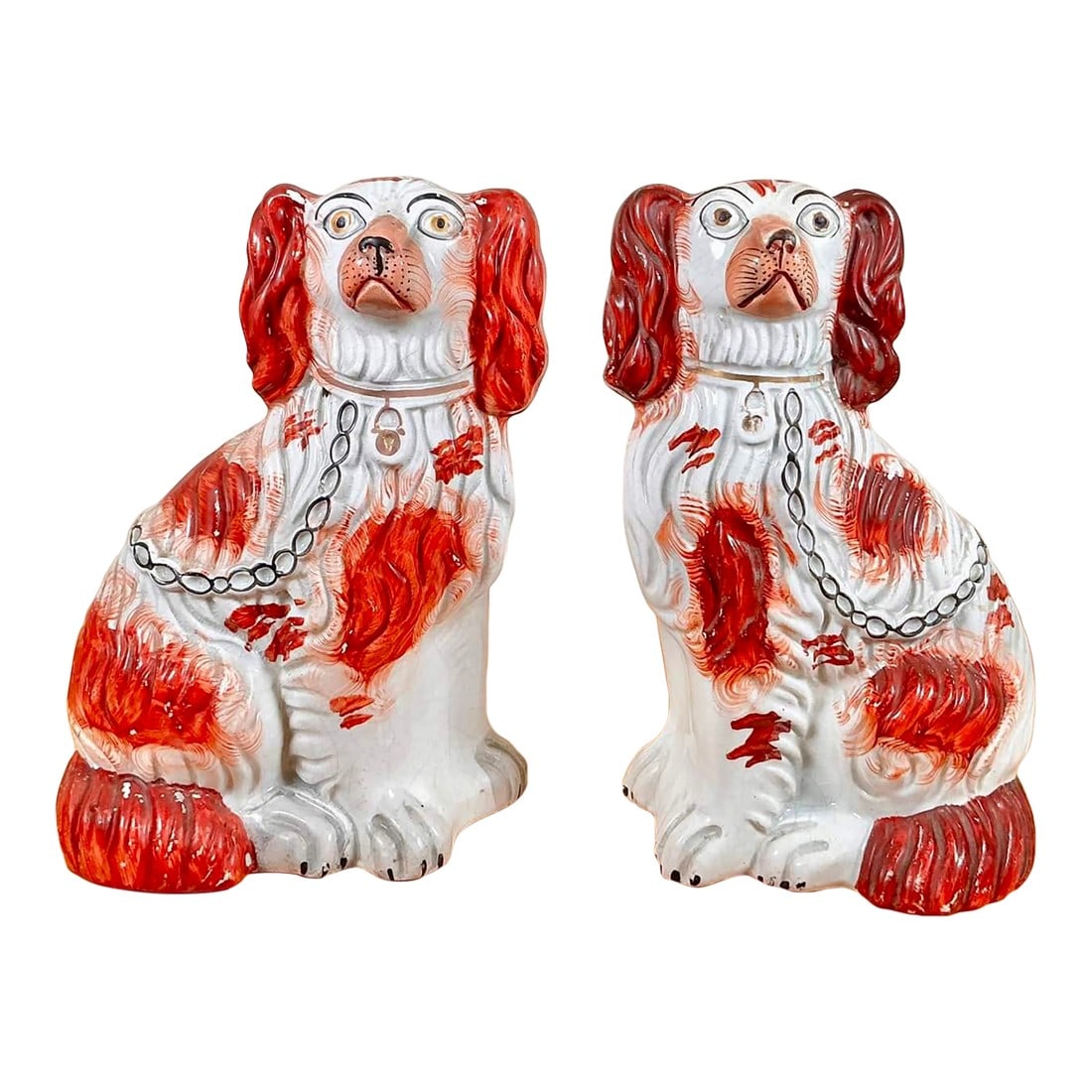 Pair of Antique Staffordshire King Charles Spaniel Figurines: Right and left ceramic dogs figurines feature a white base coat with hand painted rust-colored patches. 5.75" (length) x 3.75" (depth) x 9" (height) Condition: Alterations: Original Condition