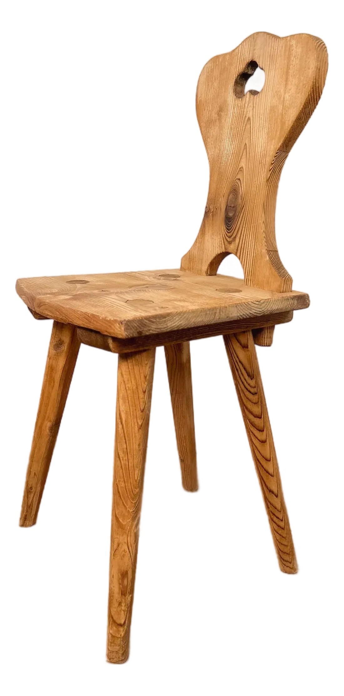 1920s Set of Two French Primitive Alpine Chairs: 1920s French primitive chair from Lorraine, handcrafted from solid pine. With its simple silhouette, honest materials, and warm natural patina, this charming piece reflects the rustic beauty and