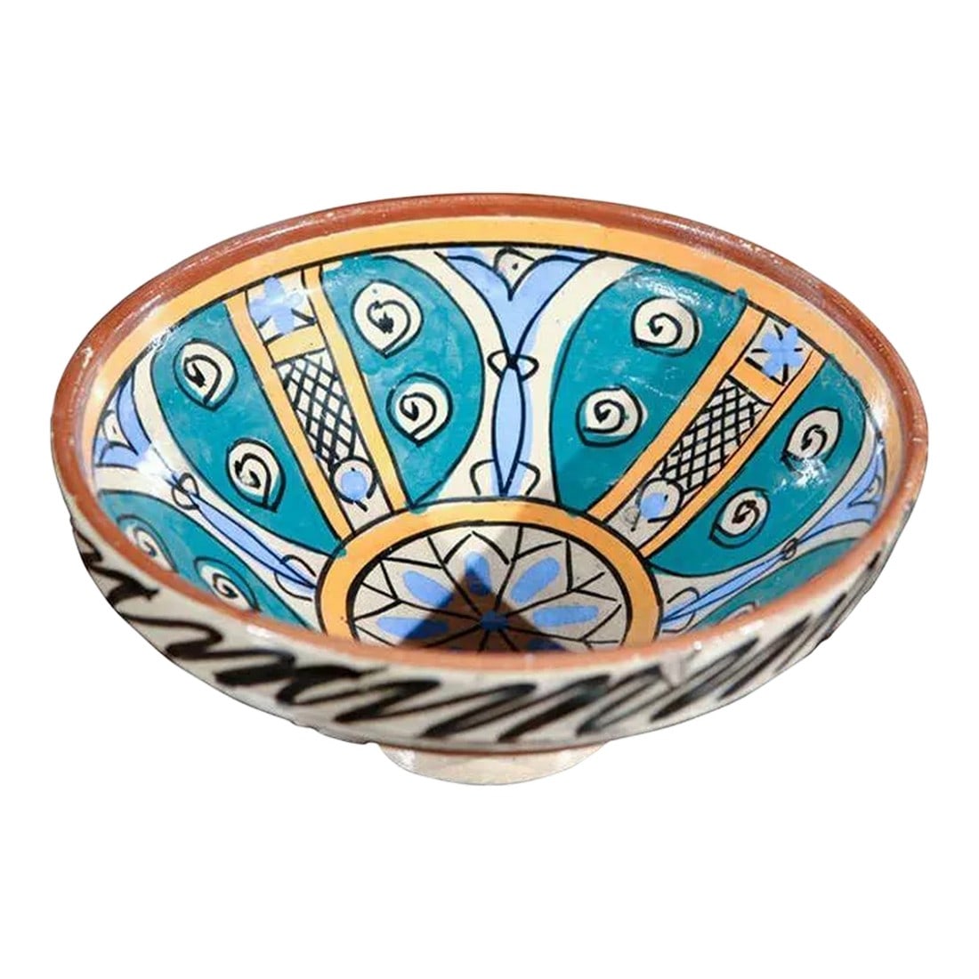 Antique Moroccan Pottery Bowl: An under-glazed painted pottery bowl with abstract naive design, blue, ochre and brown. Moroccan pottery bowl of deep rounded form with flattened rim rising on a low foot, hand-painted on the