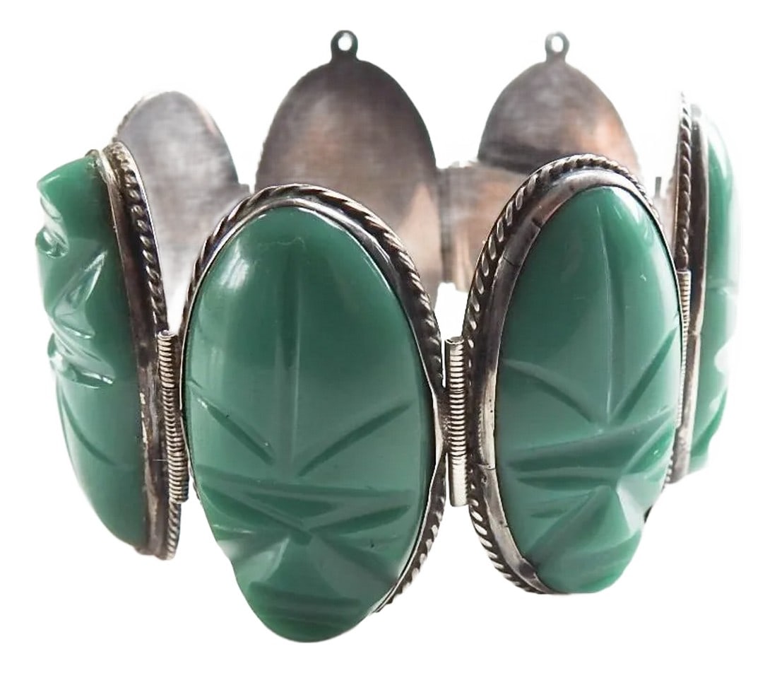 Mid 20th Century Carved Green Onyx and Sterling Silver Mexico Artisan Bracelet: Mid 20th century artisan studio carved green onyx and sterling siver bracelet. Marked Mexico and Sterling on back, carved face green onyx bezel set in sterling and linked, good solid clasp, each face 