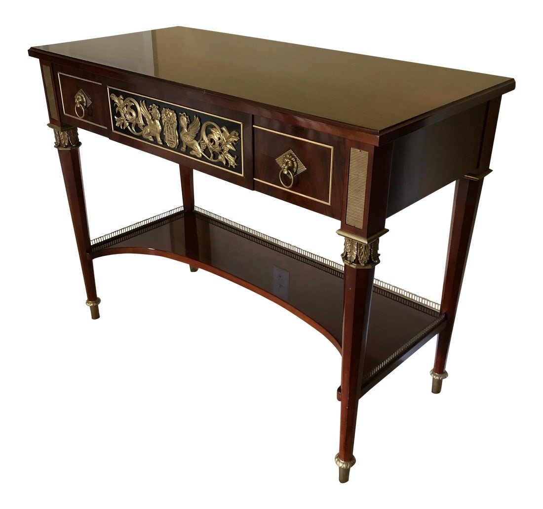 Neoclassical John Widdicomb Console Table: A very rich mahogany neoclassical style console table beautifully crafted by John Widdicomb, having ebonized front center drawer with gorgeous brass decoration flanked by two smaller drawers with hand