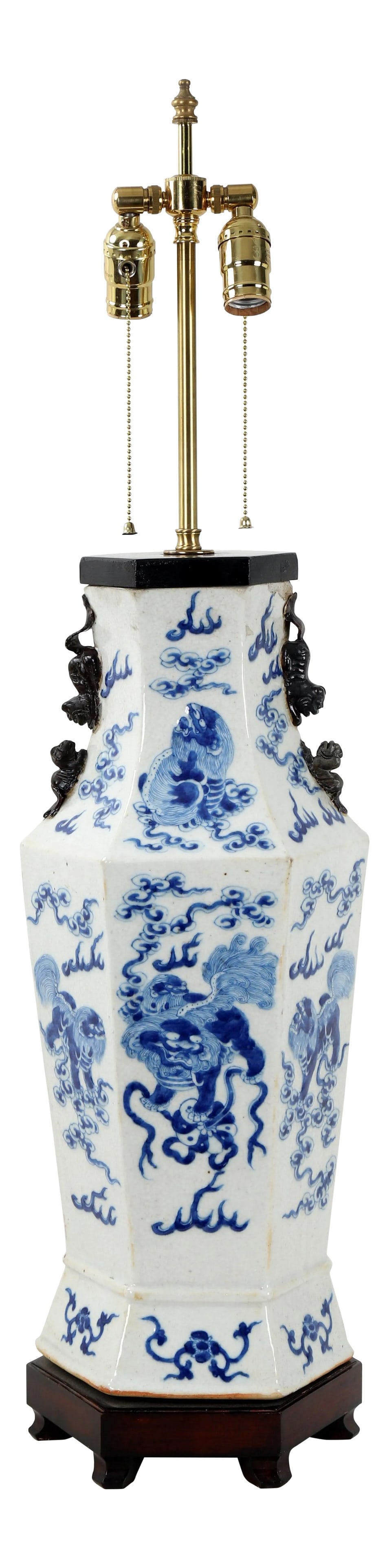19th Century Chinese Qing Dynesty Double Bulb Pull Switch Hexagonal Blue & White Porcelain Lamp With: This 19th century Double Bulb Pull Switch Hexagonal Blue & White Porcelain Lamp with Animal Figure Handles feature decorative lions playing with toy wheels and standing on clouds. Condition: