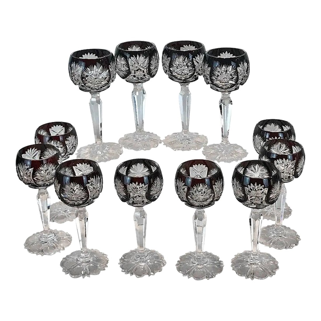Late 19th Century Ruby Red Cut to Clear Cordials - Set of 12: Set of 12 ruby red cut to clear cordials, attributed to St. Louis, Each one with snowflake cut glass panels, with intricate cut six stem petal motif foot (base) Unsigned Each glass stands 4.5" h with 