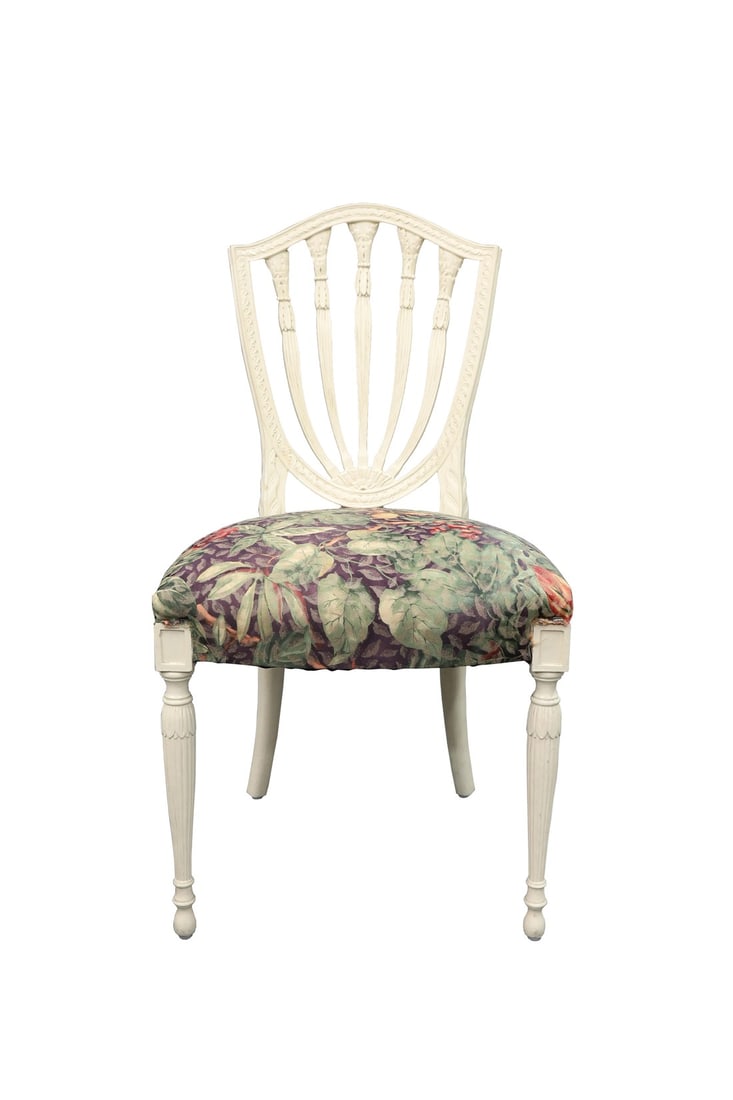 Vintage Green Leaf Seat and Palm Tree Back Chair: This vintage chair is upholstered in a purple and green leaved fabric, with a chair back that depicts 5 palms. The seat contrasts against the white and offers a pop of color. Condition: