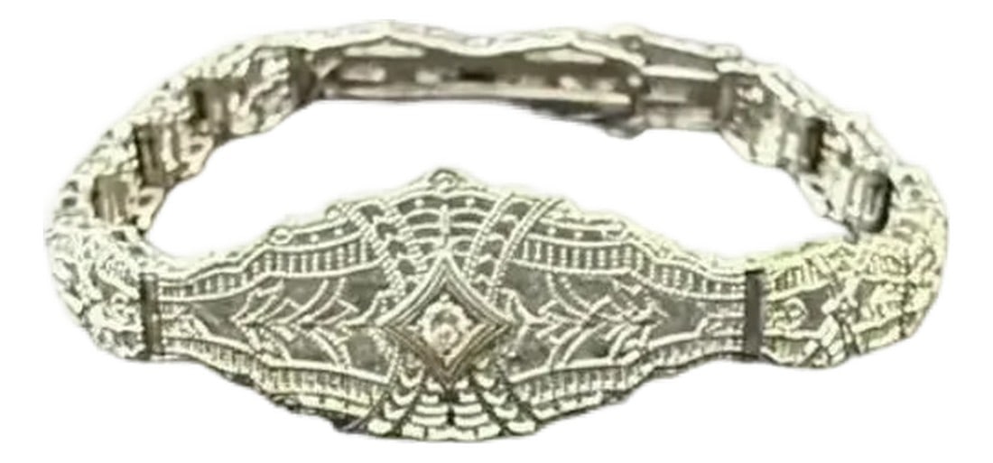 14k White Gold Filigree and Diamond Bracelet, Art Deco: Early 20th Century White Gold and Diamond Filigree Art Deco Bracelet. Bracelet features delicate openwork and a subtle geometric design. At the center is a single small diamond, bezel-set in a