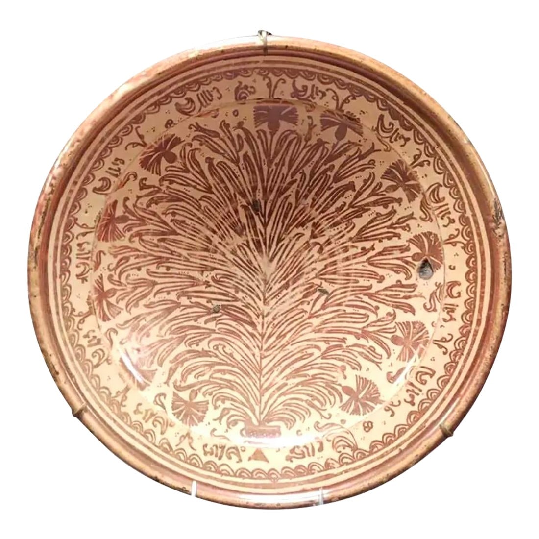 17th Century Hispano Moresque Lusterware Pottery Charger: Large 17th Century Hispano-Moresque Lusterware Pottery Charger. The charger features a deep rounded form with a rich terracotta glaze over a cream background. The central design radiates with a styliz