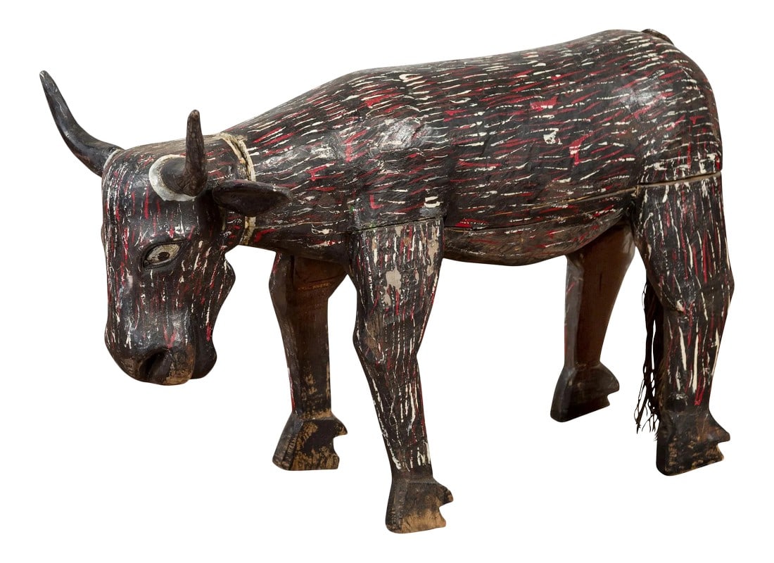 Early 20th Century Indian Hand Painted Wooden Cow with Distressed Patina: An Indian hand painted and carved wooden cow from the early 20th century, with nicely weathered patina. Created in India during the early years of the 20th century, this wooden cow sculpture charms us