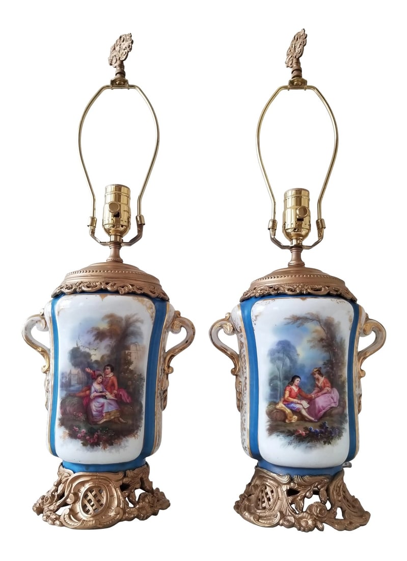 Antique Paris Porcelain Lamps: Beautiful antique French porcelains with hand painted details and metal mounts ...newer wiring and harps. Turned one way has flowers and the other way figures. Condition: Alterations: Original Design