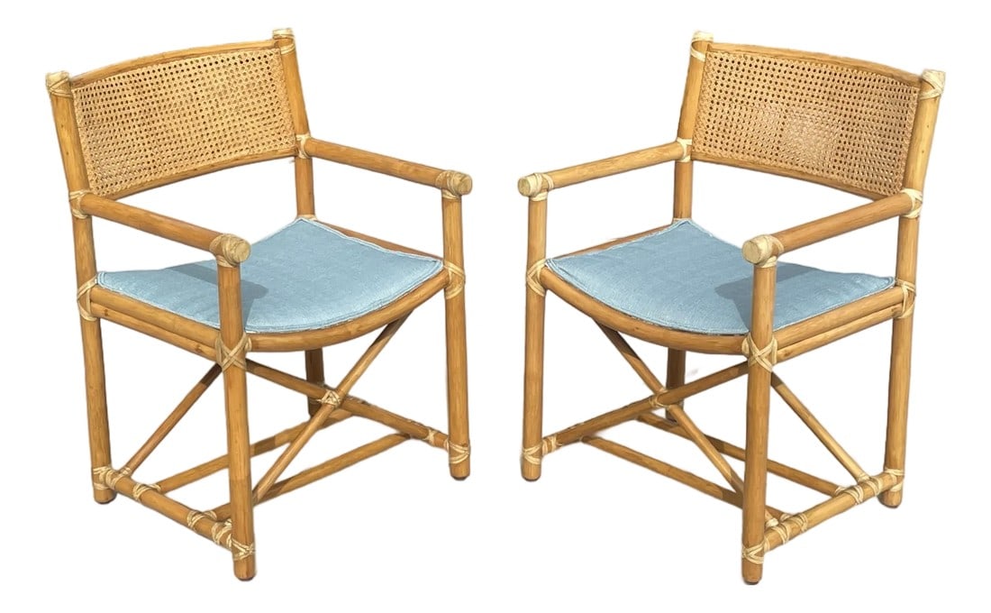Pair of Vintage Rattan McGuire Directors Style Armchairs, Newly Upholstered Sunbrella Seats: Offering a rare pair of vintage rattan dining chairs by luxury brand McGuire of San Francisco. Crafted with the superior design McGuire is known for, these director's style armchairs feature caned