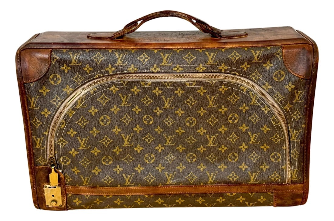 Vintage Louis Vuitton Canvas & Leather Monogram Diminutive Suitcase, Circa 1970s: Vintage Louis Vuitton canvas & leather monogram diminutive suitcase, circa 1970s This vintage Louis Vuitton monogram suitcase, made in the 1970s, exemplifies the brand's timeless elegance and craftsma
