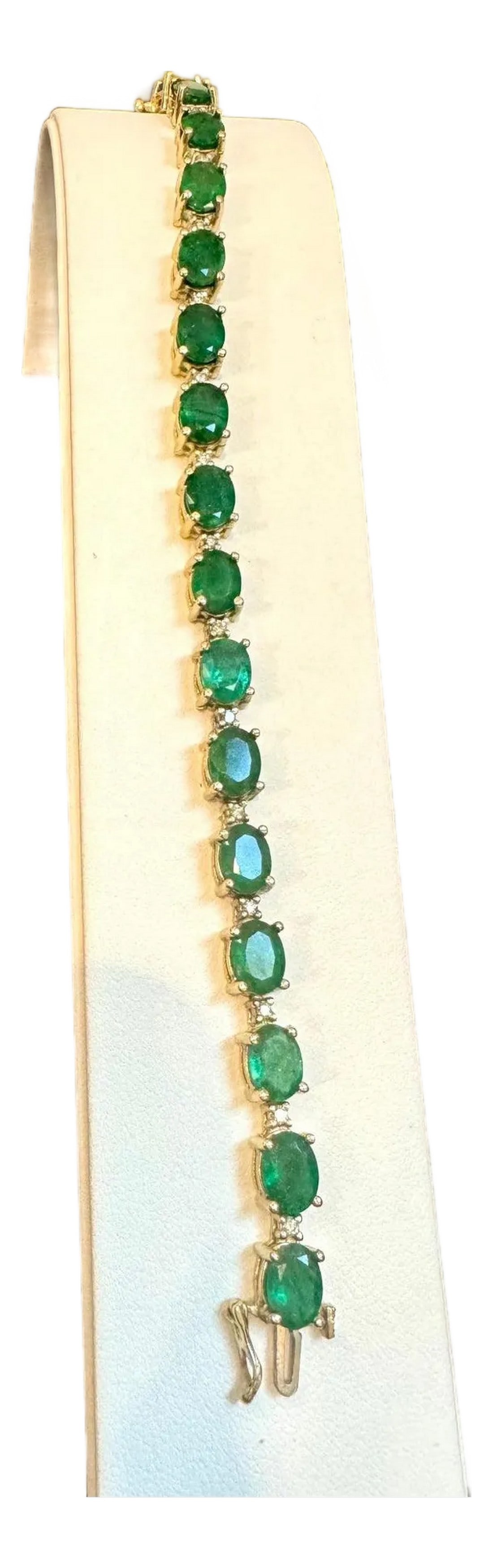 22 Carat Natural Brazilian Emerald & Diamond Tennis Bracelet 14 Kt Yellow Gold: This exceptionally affordable Tennis bracelet has 19 stones of oval Emeralds . Each Emerald is spaced by two diamonds . Total weight of the Emeralds is approximately 15 carat. Total number of