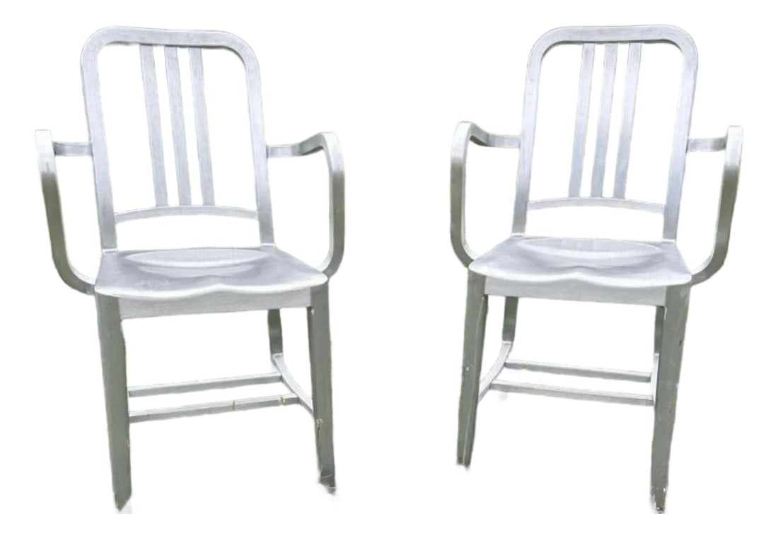 1990s Emeco Brushed Aluminum Armchairs, Pair: A handsome pair of authentic Emeco armchairs in brushed aluminum, dating to the 1990s. With their signature combination of lightness, strength, and crisp industrial lines, these chairs offer the