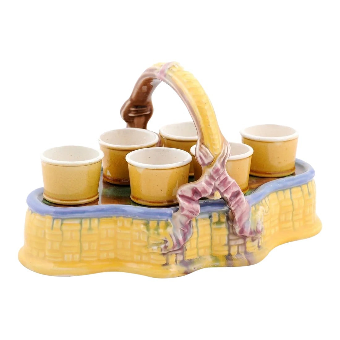 French 19th Century Majolica Porcelain Yellow Glazed Basket with Egg Cups Set- 7 Pieces: A French yellow glazed majolica porcelain basket from the 19th century, with a set of six egg cups and pink ribbons. Created in France during the 19th century, this majolica porcelain basket draws