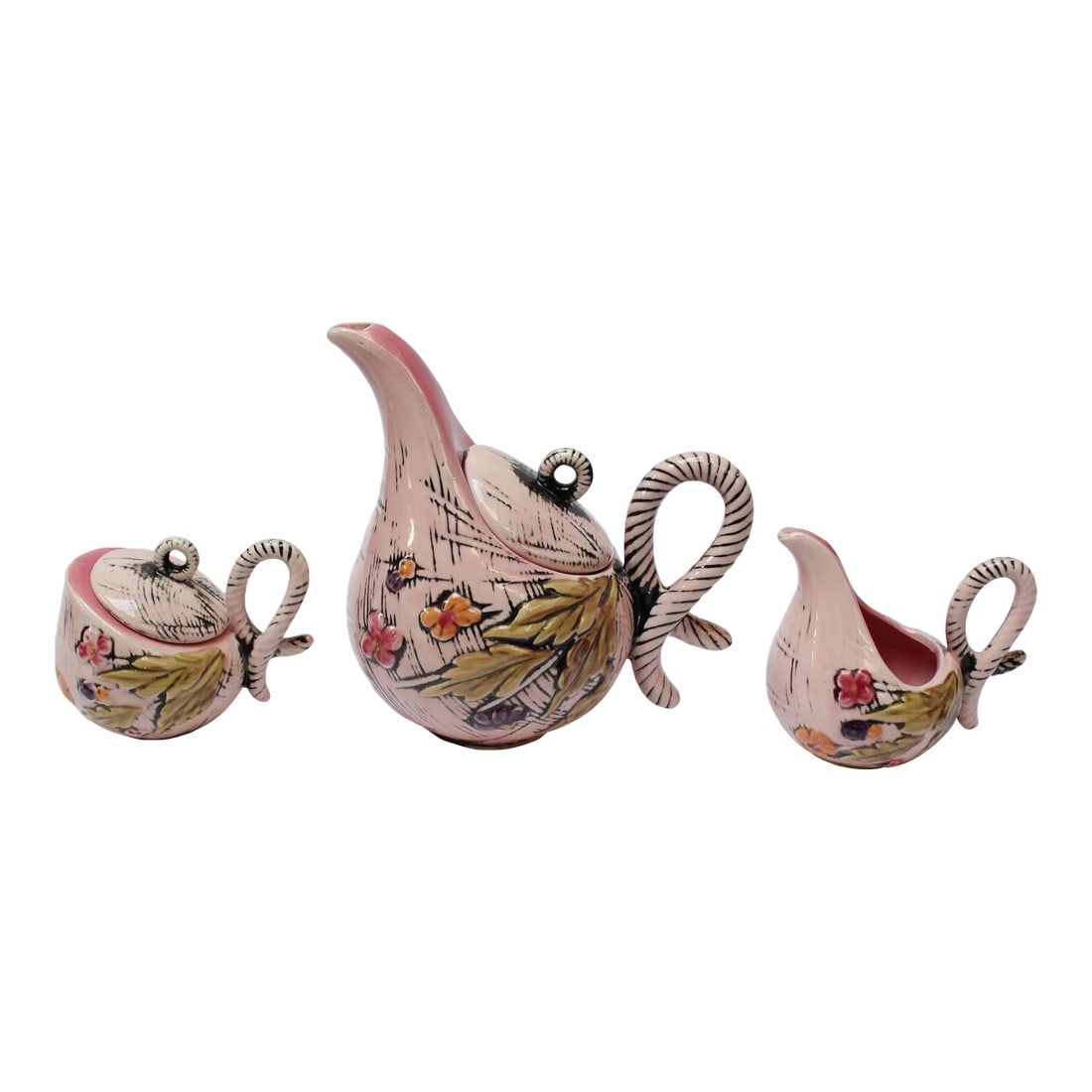1950s Hull Pottery "Blossom Flite" Tea Service- 3 Pieces: Charming ceramic tea / coffee set including teapot, sugar, and creamer by Hull Pottery in the "Blossom Flite" pattern (1955, USA). Modernist form with sweeping lines and curves. Pale pink with floral 