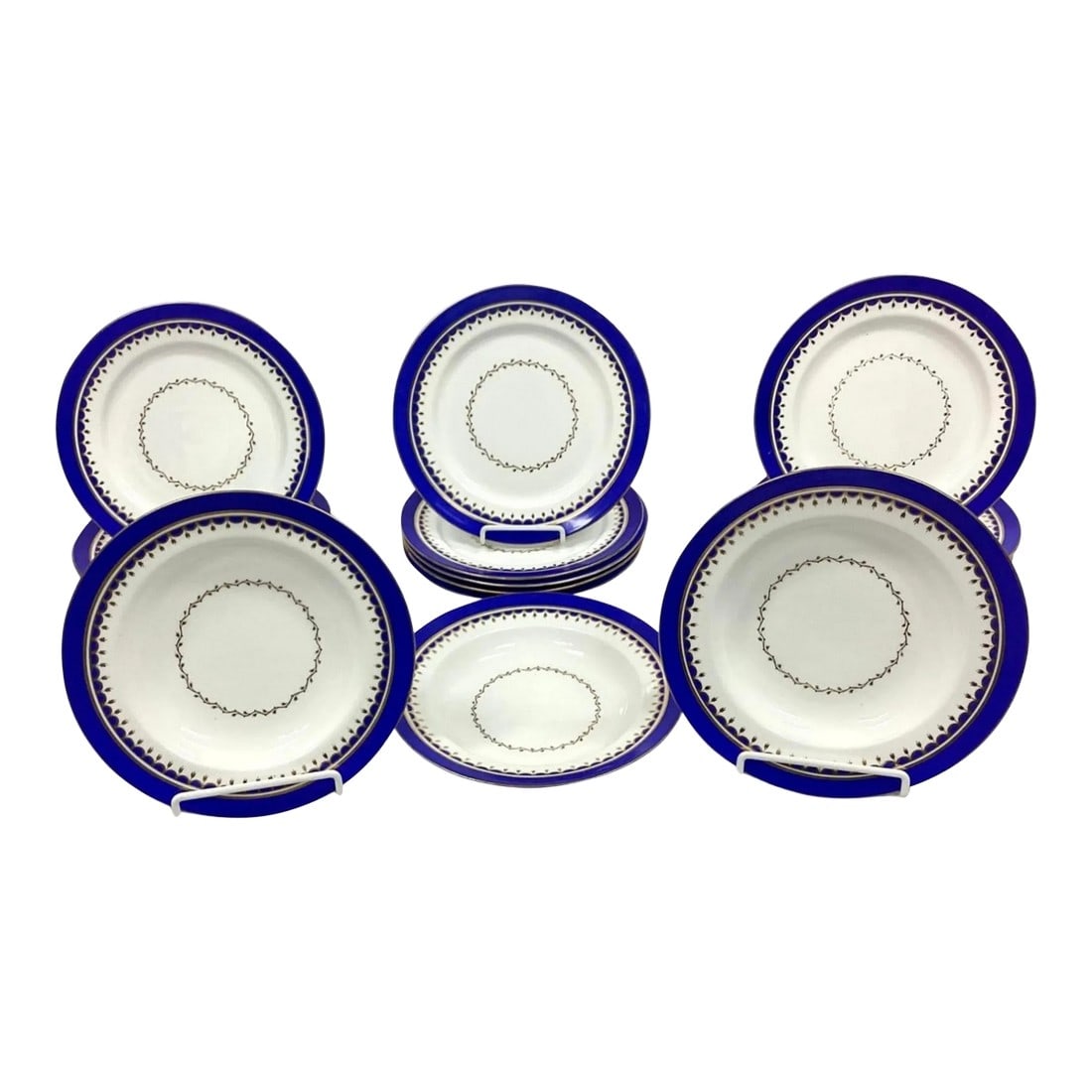 Set of Vintage Porcelain Dinner Plates and Bowls, Early 20th Century: Set of early 20th Century Porcelain Dinner Plates (16 total) and large bowls (3 total). Beautiful cobalt blue on edge with smooth gold trim and tiny gold leaves in center. No markings on reverse