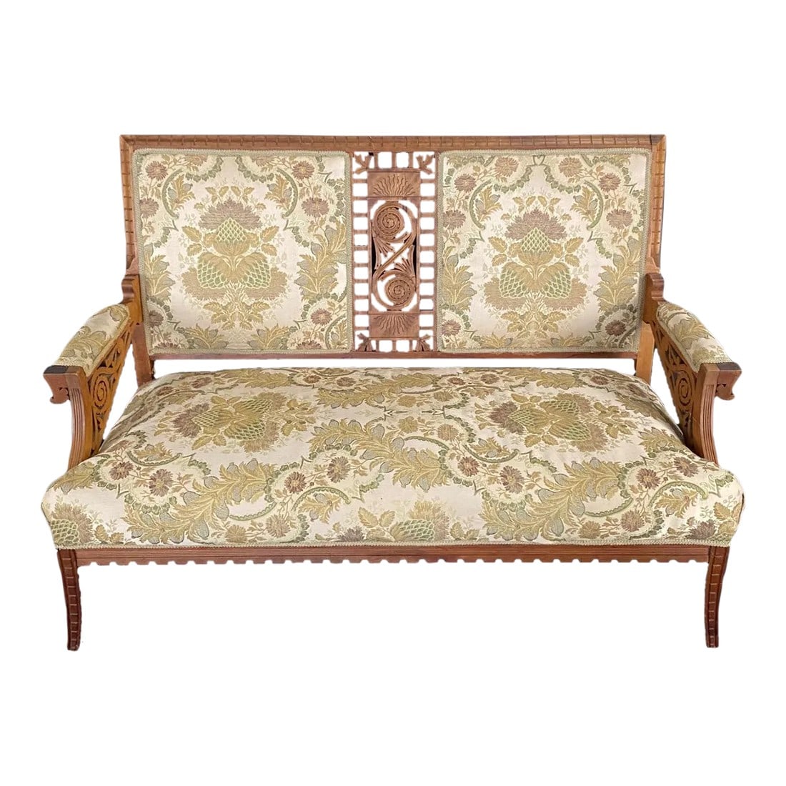 Authentic Rare Eastlake Aesthetic Movement Ornate Carved Walnut Loveseat: An Eastlake period sofa loveseat or settee centered with a stunning pierced crest having a pierced floral motif with the shape mirrored in the arm pediments. Beautiful outward rolled arms are finished