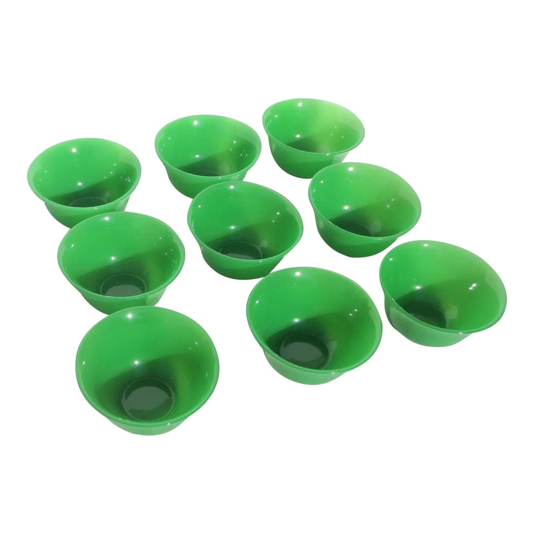 Peking Glass Tea Bowls -Set of 9: A fine group of Peking glass tea bowls, a group of 9 pieces. Beautiful green translucent green jade color. Soft smooth hand bowls with gentle curvature and soft cut bottom rims, see detailed photos.