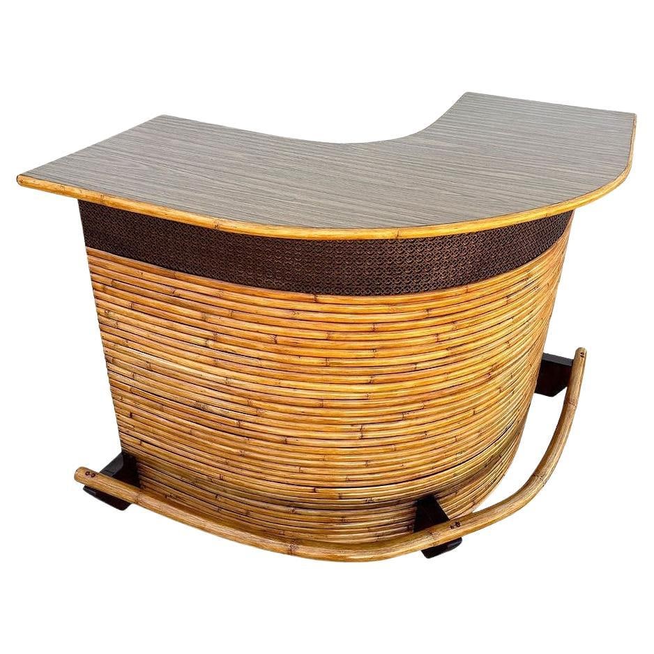 Restored Horizontal Stacked Restored Rattan L-shaped Corner Bar w/ Foot Rest: Title: Restored Horizontal Stacked Restored Rattan L-shaped Corner Bar w/ Foot Rest Description: This beautifully restored, Large 68" wide stacked rattan curved Mid-century dry bar. The bar has two sh