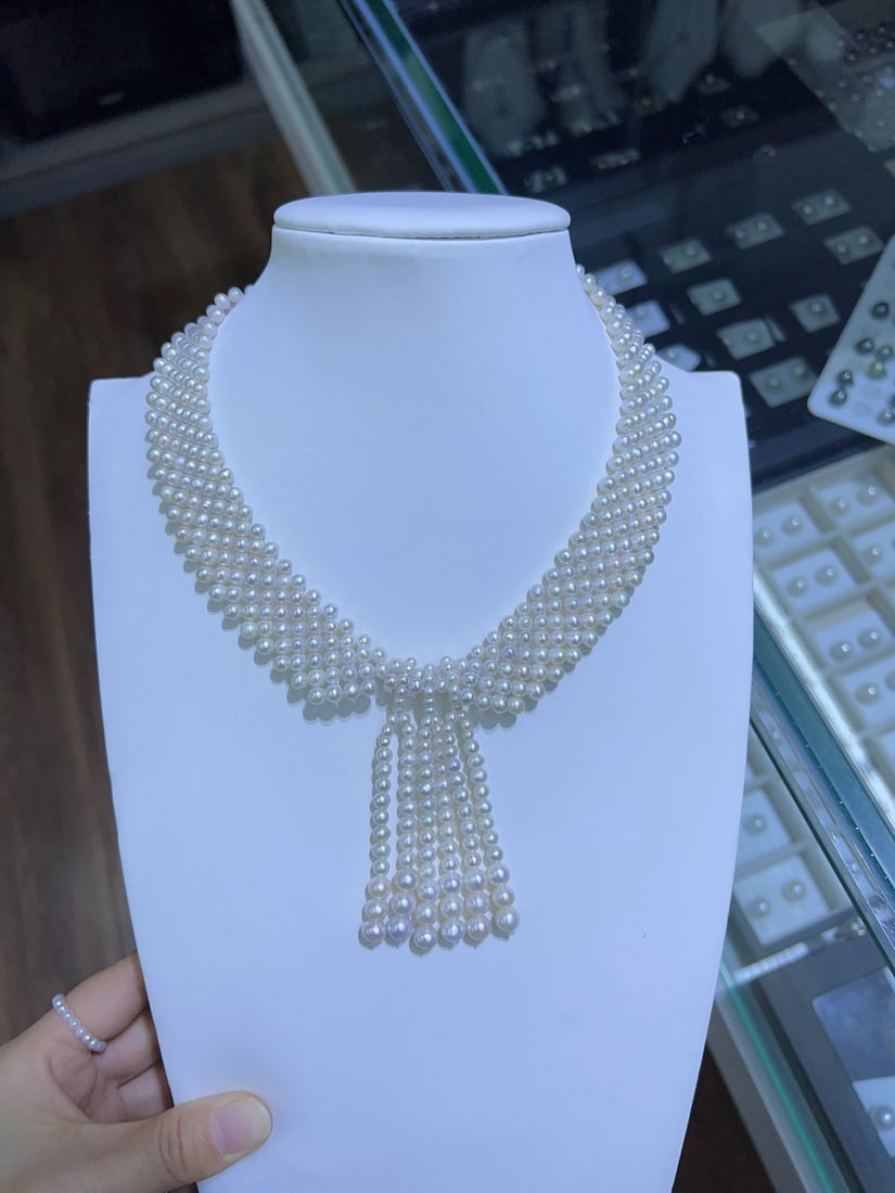 Pearl Necklace: This necklace features natural pearls with diameters of 4-5mm and 6-7mm, showcasing a strong bright white luster with minimal blemishes. The handcrafted woven design exudes unique charm. Reserve: $250