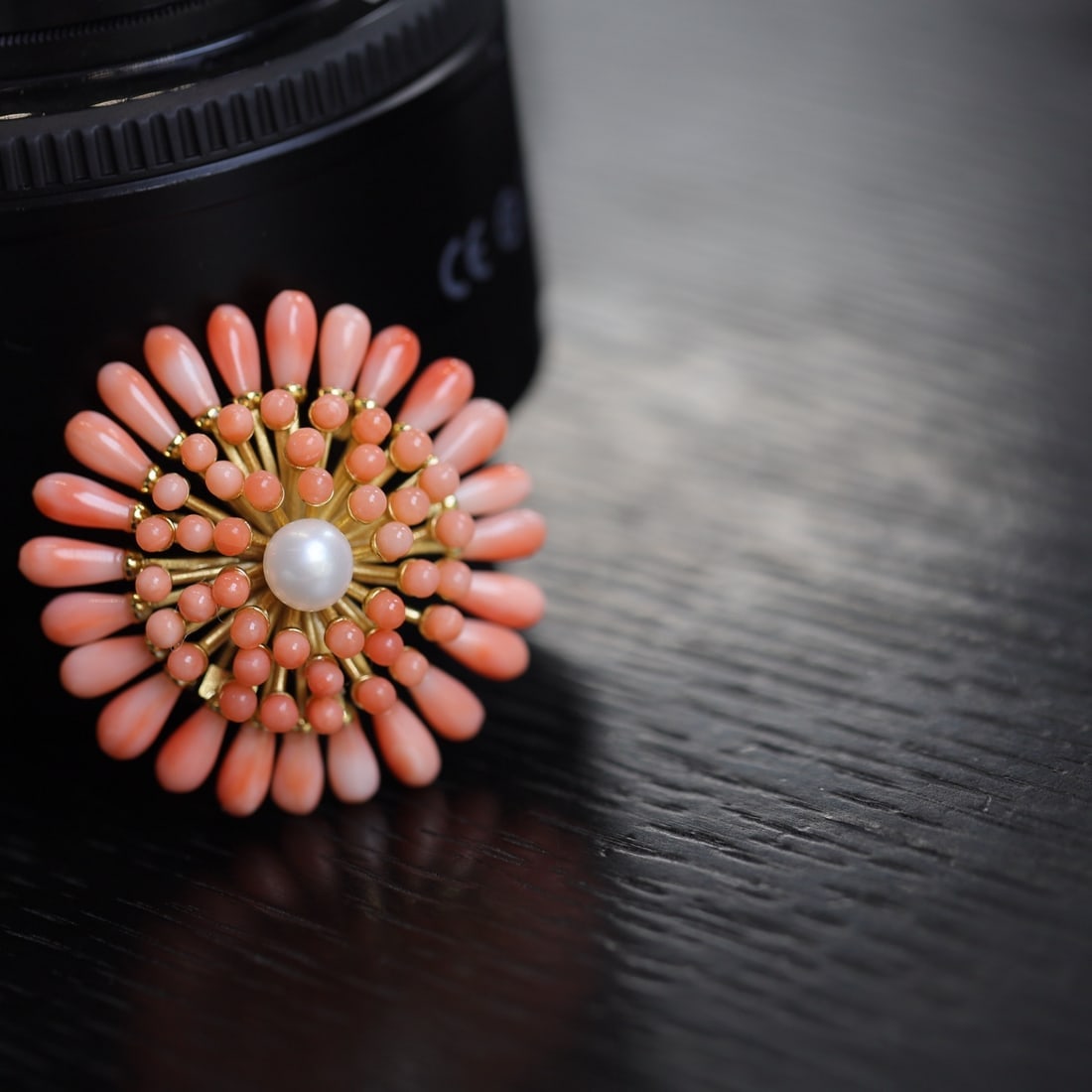 Natural Red Coral Brooch: This natural red coral brooch exudes luxury and elegance. The vibrant coral petals are complemented by a gentle pearl center, with intricate gold filigree enhancing its exquisite detail. Perfect for b