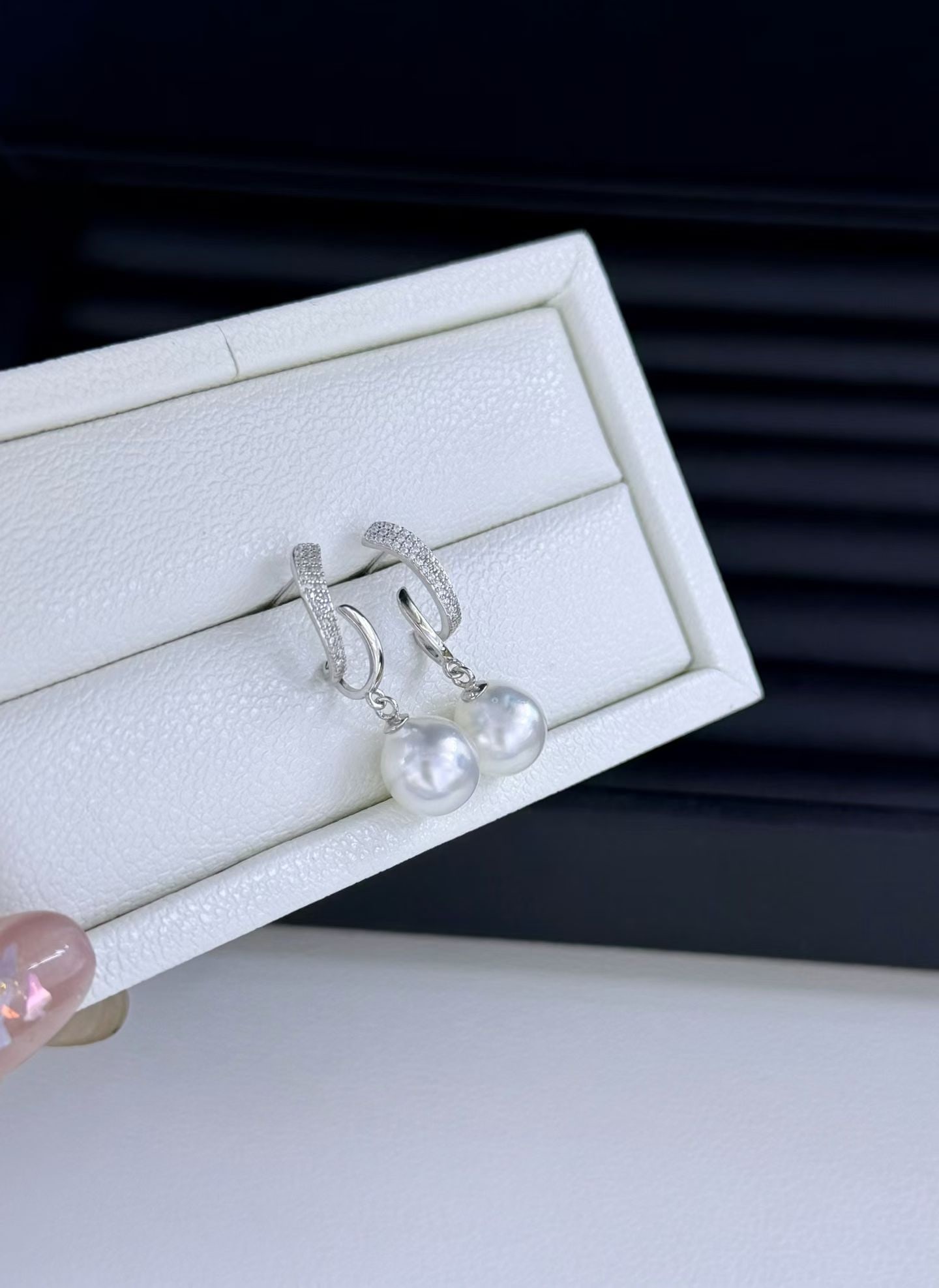 S925 Silver Natural Australian White Pearl Earrings: These earrings feature natural Australian white pearls with a strong luster in a cool white hue. The pearls are 9-10mm in diameter, near-round, and have minimal blemishes. Crafted with S925 silver for