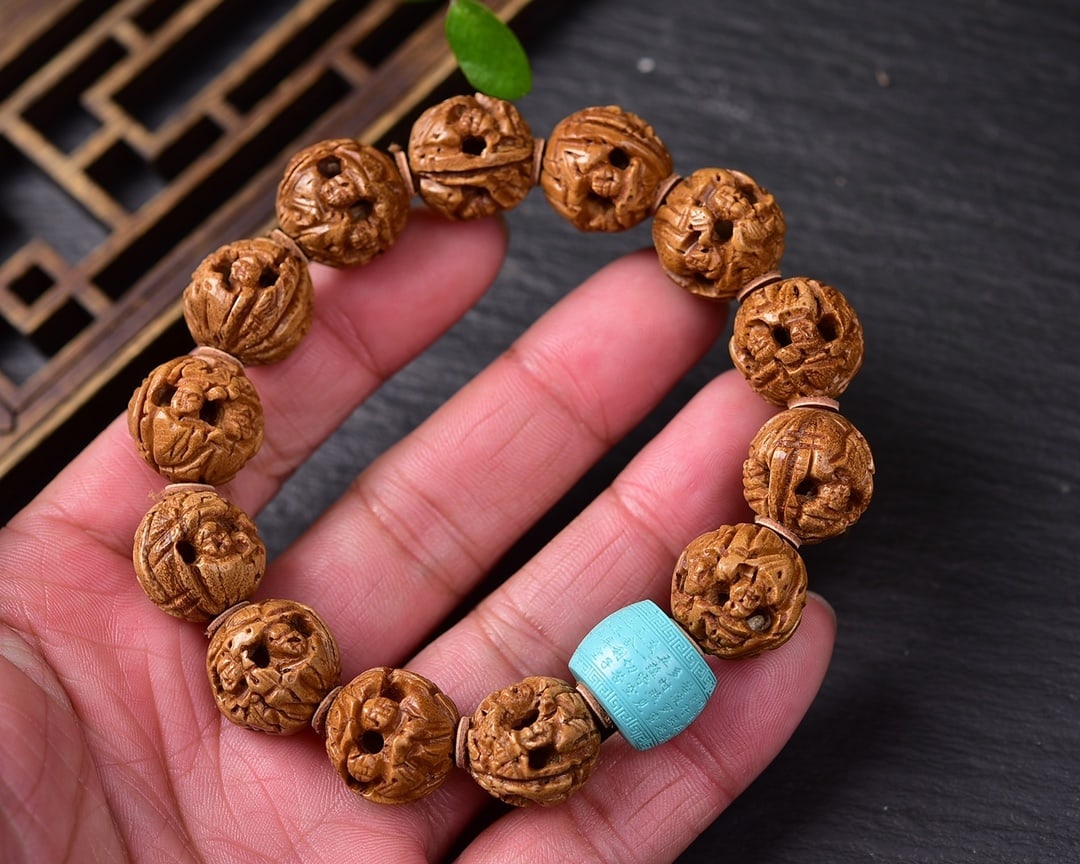Natural Peach Stone and Turquoise Bracelet: This bracelet is crafted from natural peach stones, embodying the traditional belief of warding off evil. Paired with cool white turquoise beads, it adds a unique texture and visual appeal. Each bead 