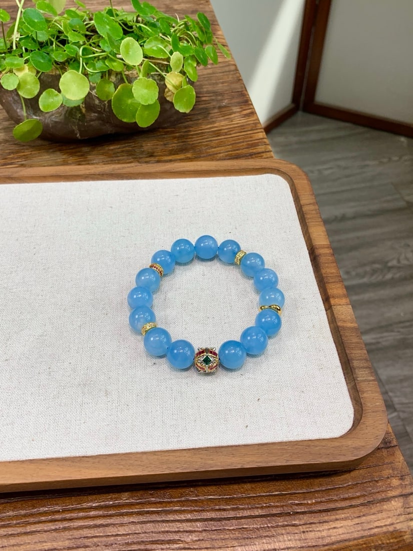 Natural Aquamarine Bracelet: This natural aquamarine bracelet exudes elegance with its cool white tone and large 13mm diameter. Each aquamarine is meticulously selected to showcase its natural icy translucence. The bracelet featu
