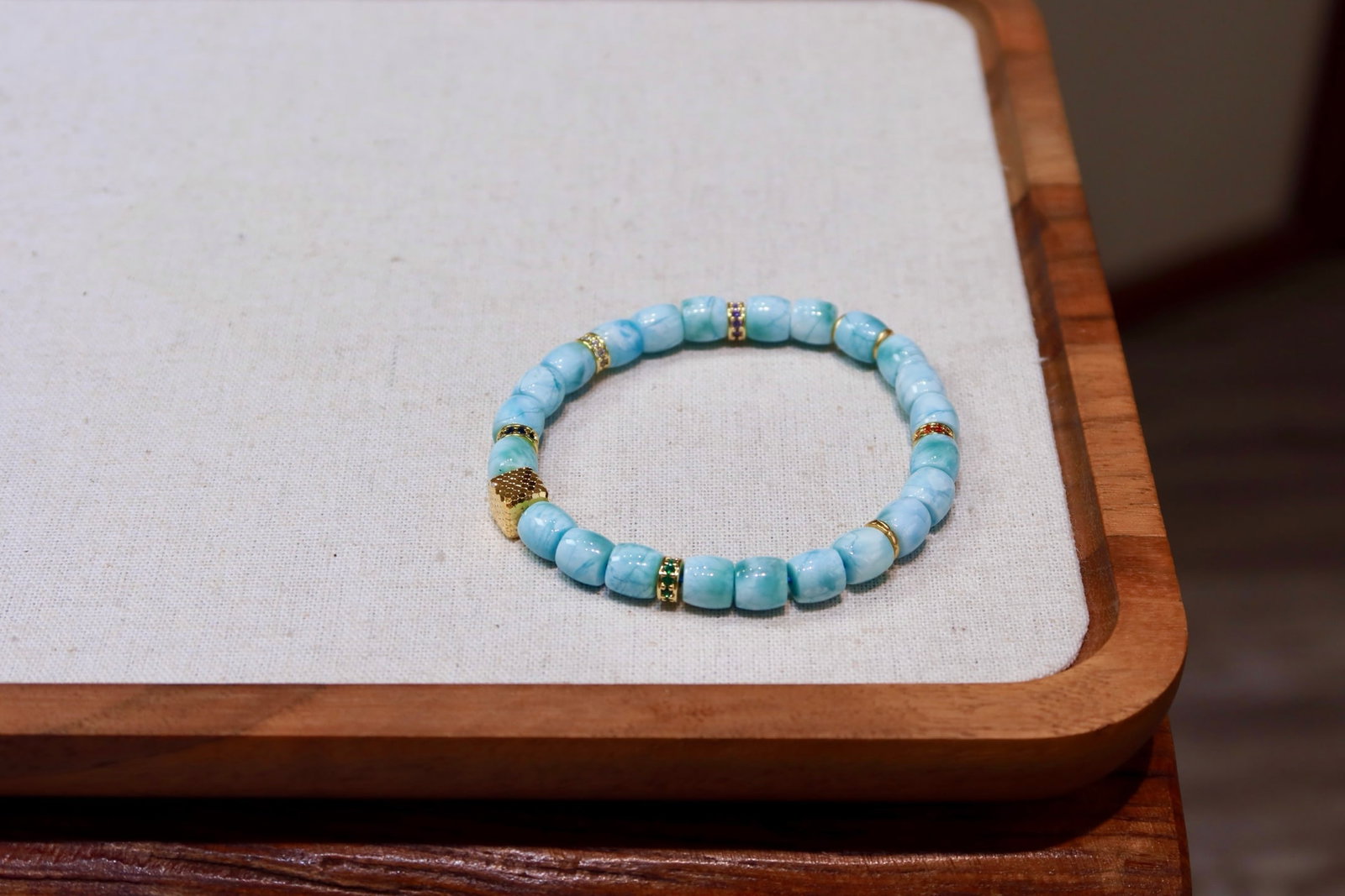 Natural Larimar Bracelet: This natural Larimar bracelet showcases a unique cool white hue. With large diameter beads and minimal blemishes, it captivates at first sight. The exquisite craftsmanship of gold with diamond-studded