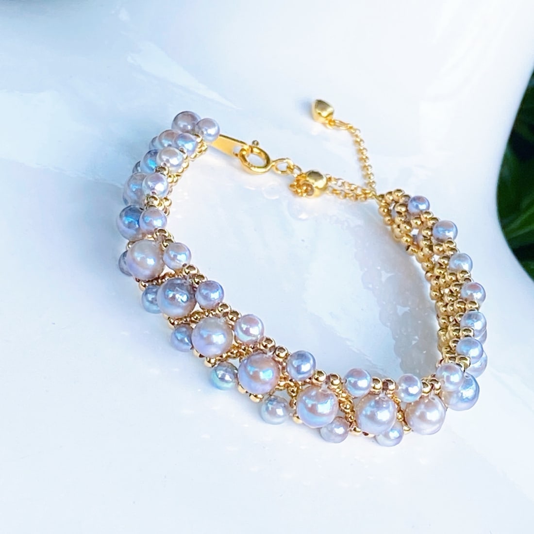 Sterling Silver Natural Akoya Pearl Bracelet: This bracelet features sterling silver inlay with 3-4mm perfectly round, minimally flawed Akoya pearls, showcasing a natural luster of rich gold and cool white. Each pearl is meticulously selected for