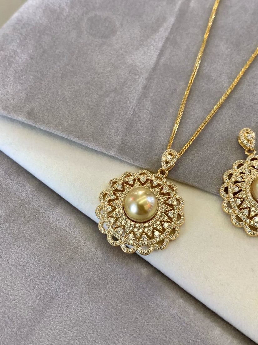 S925 Silver Natural Saltwater Gold Pearl Pendant: This pendant features S925 silver with an intricate lace pattern, exuding a vintage charm. The saltwater gold pearl, with its natural tea-gold hue and nearly perfect round shape, radiates a rich golde