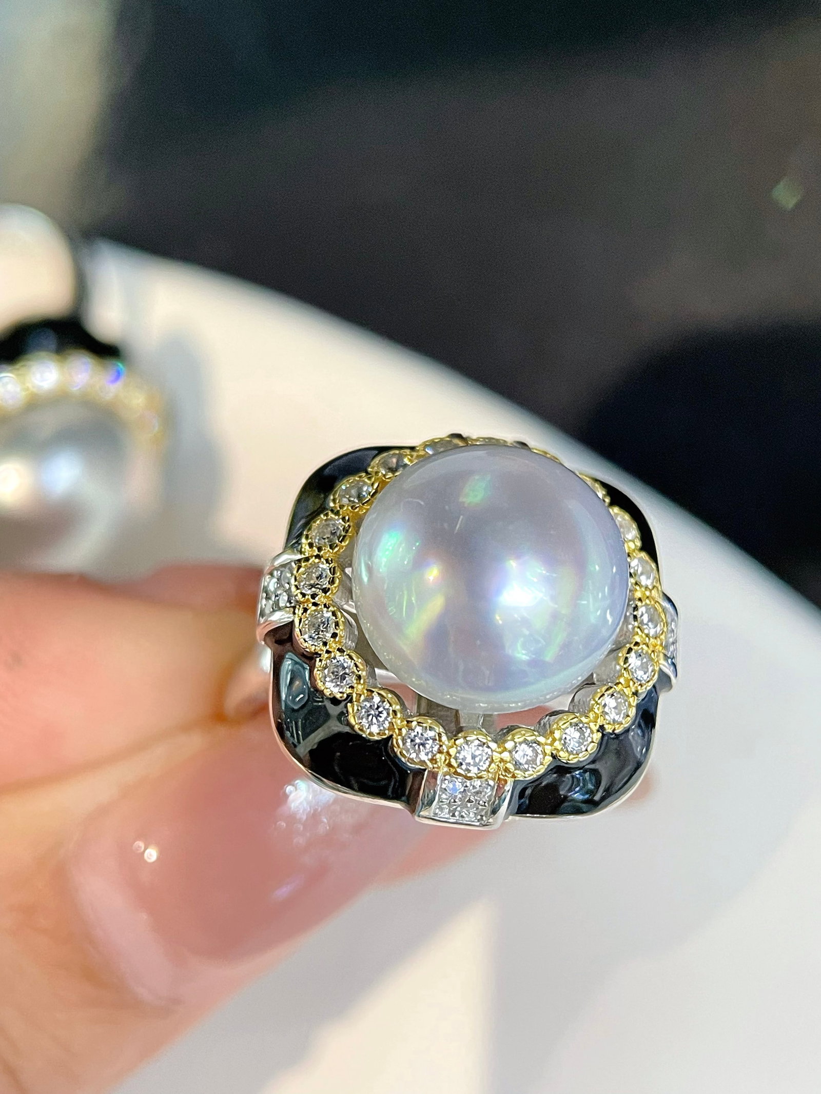 925 Silver Natural White Pearl Ring: This ring features a natural white pearl set in 925 silver, exuding a cool white luster with a hint of pink. The pearl measures 12-13mm in diameter, showcasing an almost flawless round shape, epitomiz