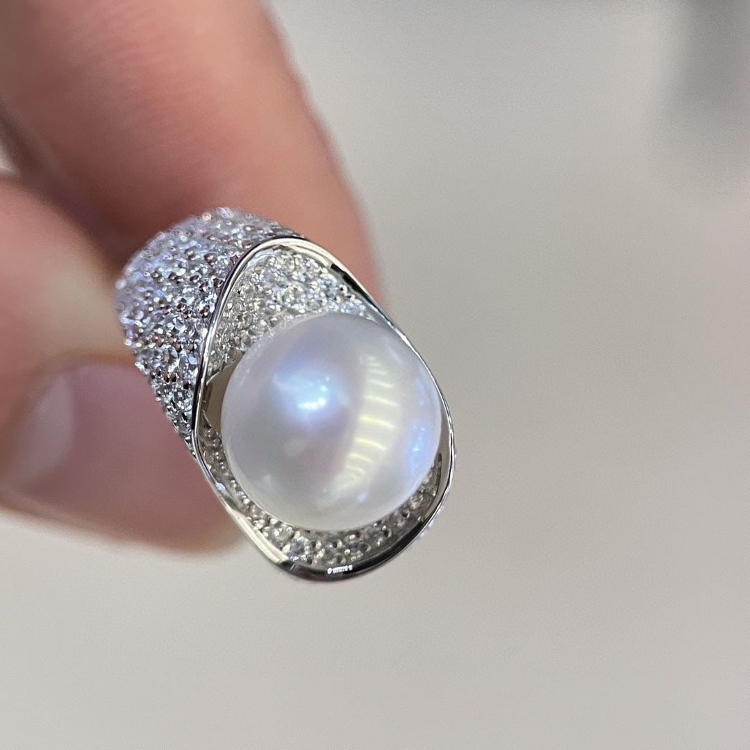 Sterling Silver Natural White Pearl Ring: This ring features a natural, non-nucleated freshwater pearl with an aurora-like, cool white luster. The pearl is large, with a diameter of 10 to 11mm, perfectly round with minimal blemishes. Crafted 