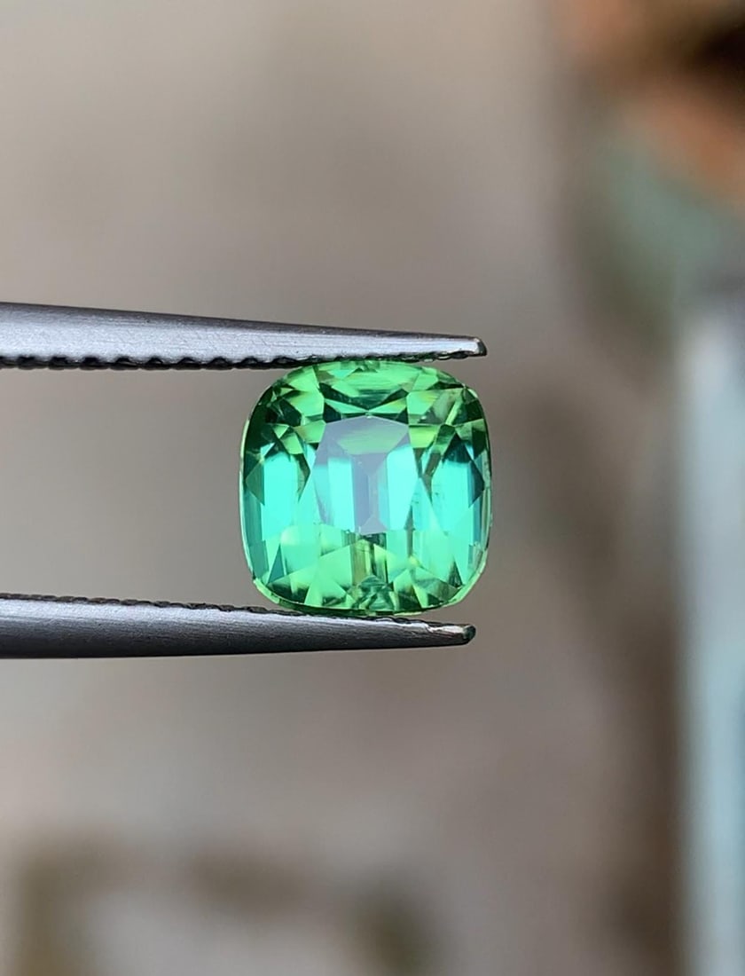Bluish Green Tourmaline Natural Gemstone For Jewellery - 2.195: Materials: Gemstone: Tourmaline Carat weight: 2.195 Tourmaline Details: * Weight : 2.195 carat * Dimension : 6.8*6.4*6.2 mm * Shape : Cushion Cut * Colour : Blue & Green * Clarity : Loupe Clean * Orig