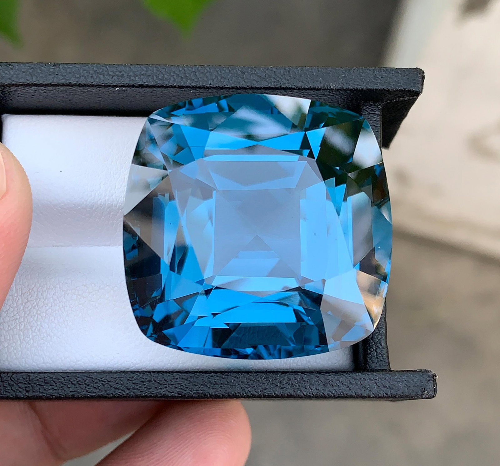 Certified Natural London Blue Topaz Gemstone: 169.29 Ct Cushion Cut Brazil Collector Stone: Materials: Gemstone: Topaz Carat weight: 169.29 Presenting an extraordinary Certified Natural London Blue Topaz gemstone weighing an impressive 169.29 carats, sourced from the renowned gemstone region