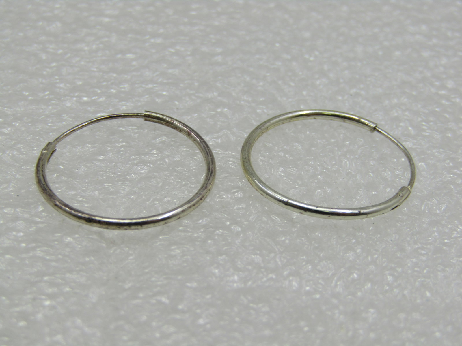 Vintage Sterling Silver 1" Hoop Pierced Earrings: Vintage Sterling Silver 1" Hoop Pierced Earrings. They have been tested and test as sterling with appx. weight of .80 gr. Age is 1960's or after. They are a tubular sterling that is appx. 1.2mm. Very