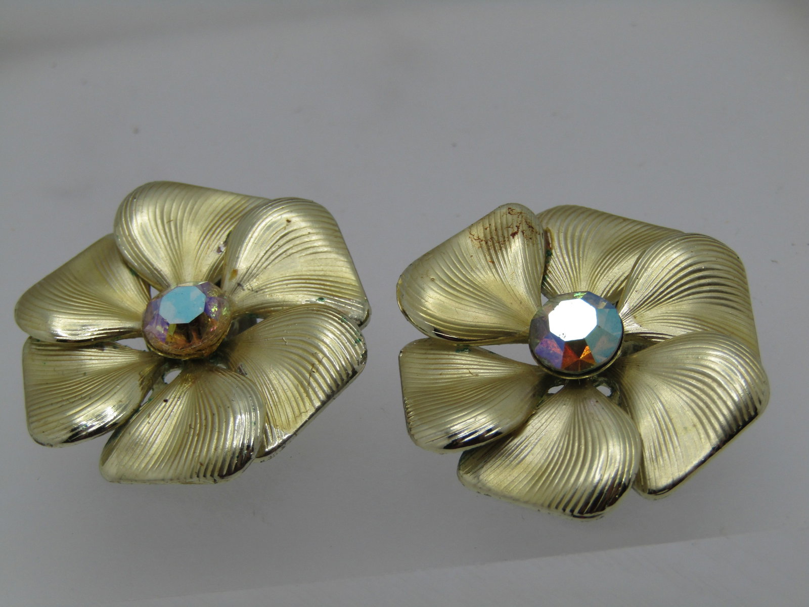 Vintage Ridged Blossom Earrings, AB Rhinestone Center 1.25": Vintage Ridged Blossom Earrings, AB Rhinestone Center 1.25", They have the center aurora borealis accent that is appx. 7.5mm. The petals have a curved design and are slightly overlapping Mid-Century 1