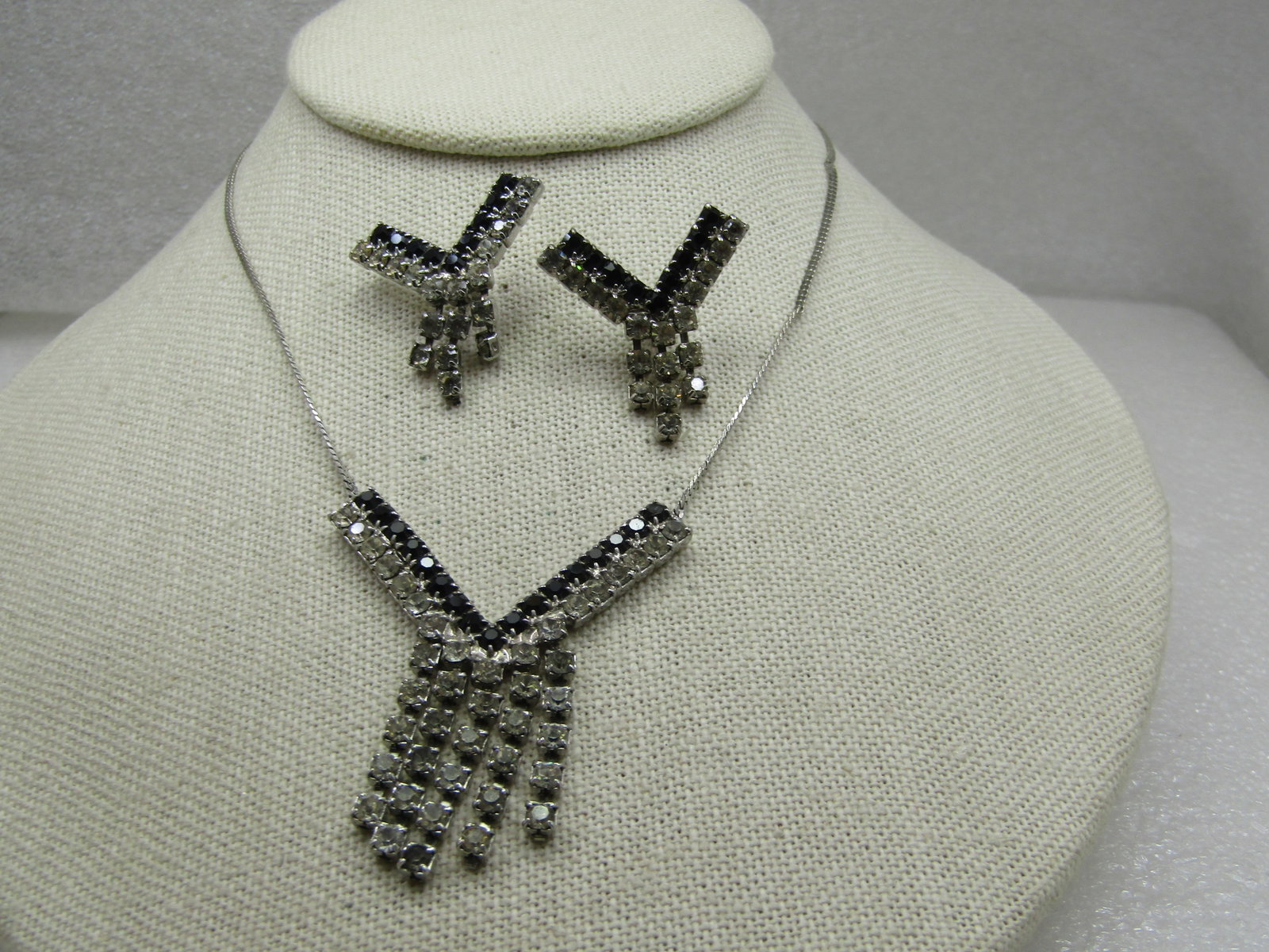 Vintage Rhinestone Necklace & Earrings, Black Clear V-Drop: Vintage Rhinestone Necklace & Earrings, Black Clear V-Drop, 14" necklace with pierced earrings set. A single row of place rhinestones in the top of the v with clear rhinestones on the lower row, sligh