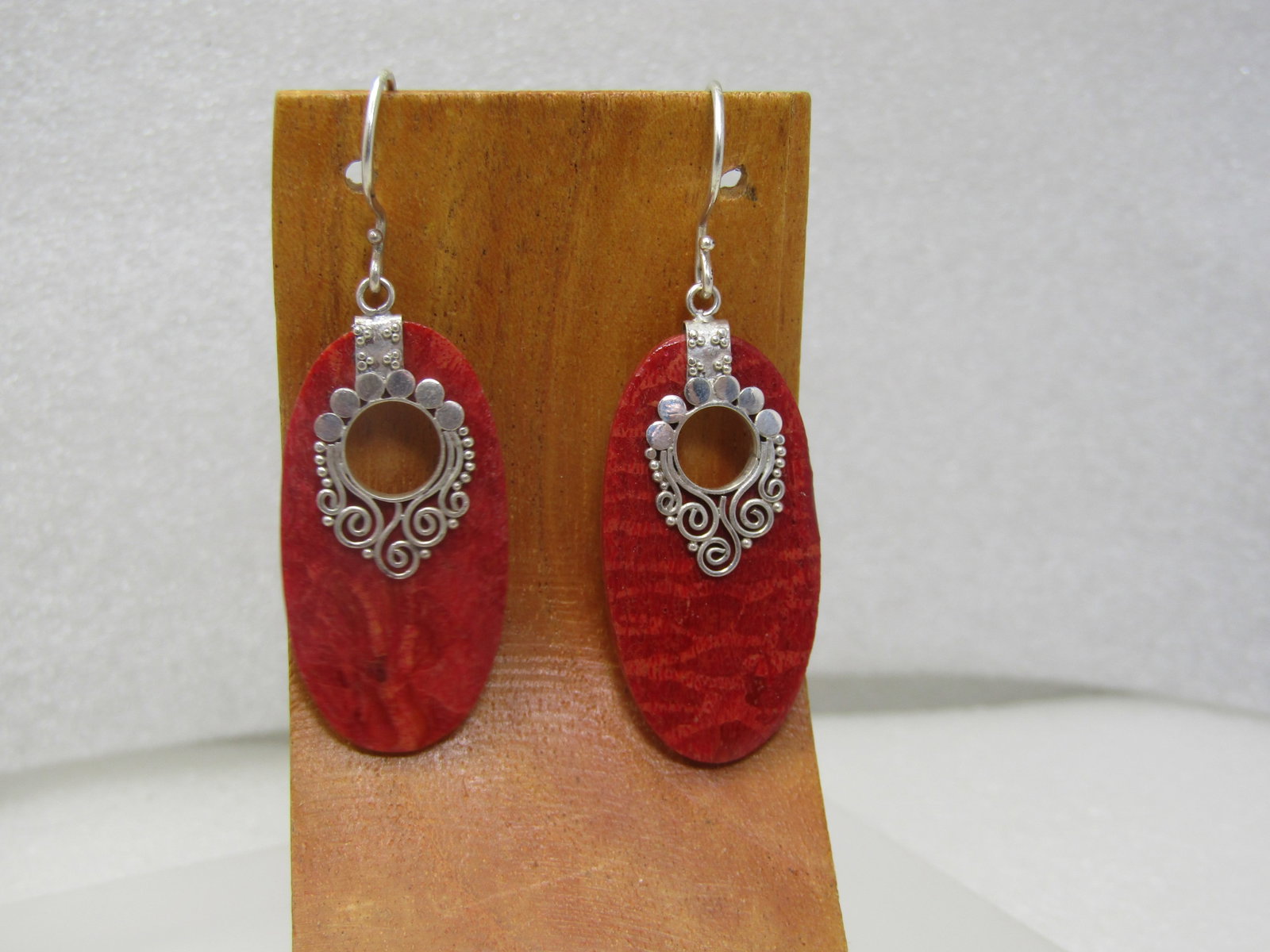 Vintage Southwestern/Bali Sterling Drop Earrings, Pierced, 1990's: Vintage Southwestern/Bali Sterling Drop Earrings, Pierced, 1990's. The drop is a flat piece of red composite stone or other material the color of red coral. It has an open circle at the top with a