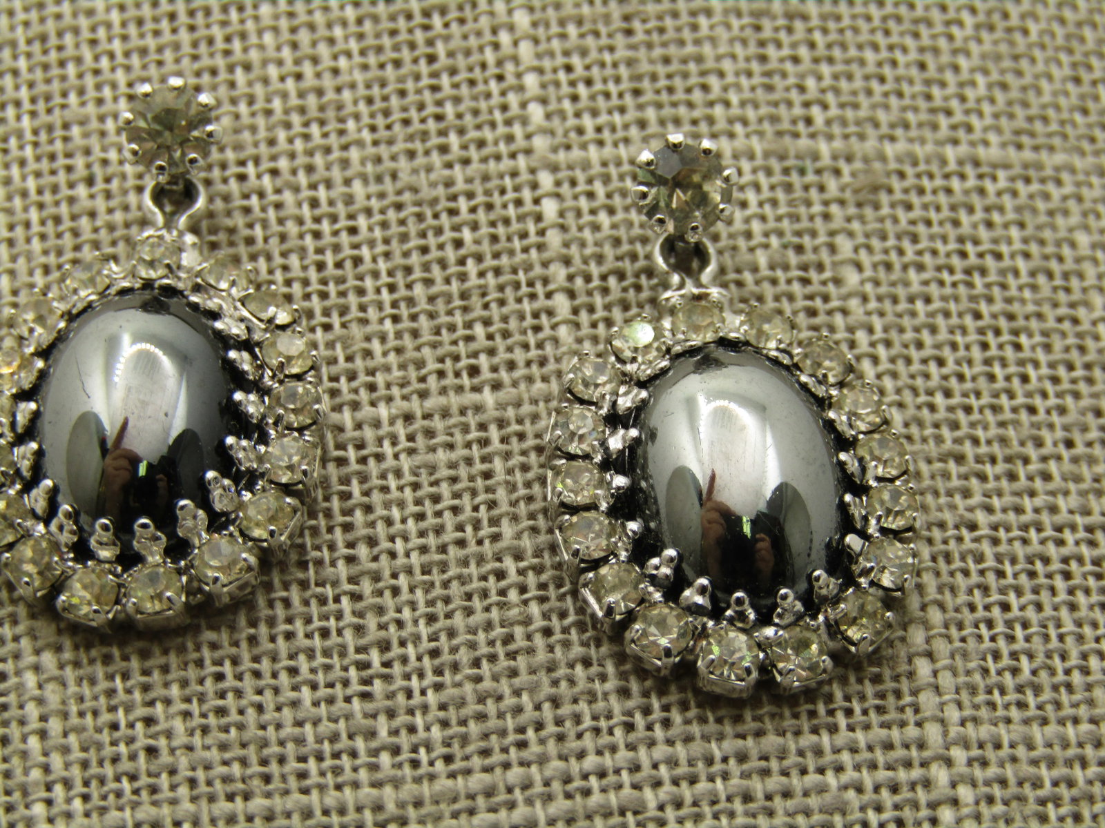 Vintage Rhinestone Hematite Drop Earrings, Art Deco Themed, 1.25": Vintage Rhinestone Hematite Drop Earrings, Art Deco Themed, 1.25". These are a contempory design of an art deco design. A center domed created hematite with a halo of clear rhinestones. Oval. They hav