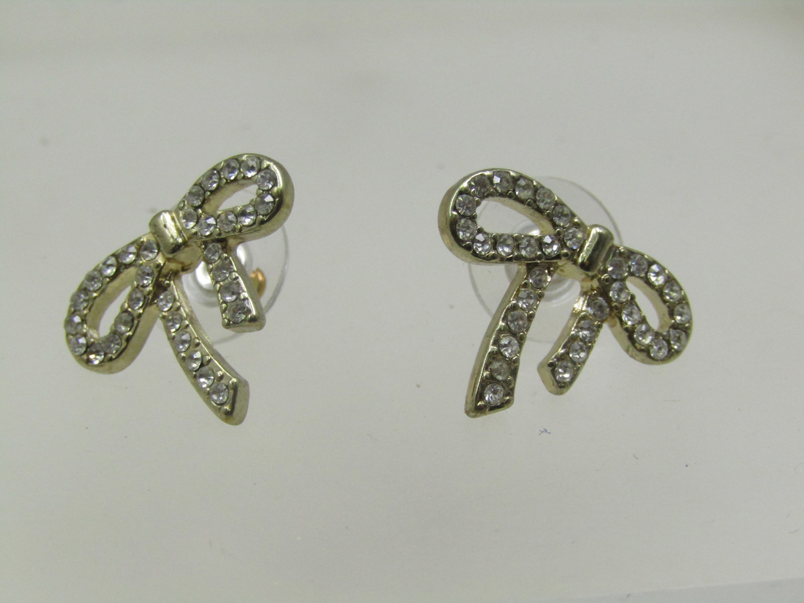 Vintage Rhinestone Bow Earrings, Pierced, Silver Tone: Vintage Rhinestone Bow Earrings, Pierced, Silver To. 7/8" wide at the bow and .75" long. Not signed or marked. 1990's. Very good condition. (W101522.4 SS8743 AZ LEB* LD 10/30/22). Reserve: $10.00