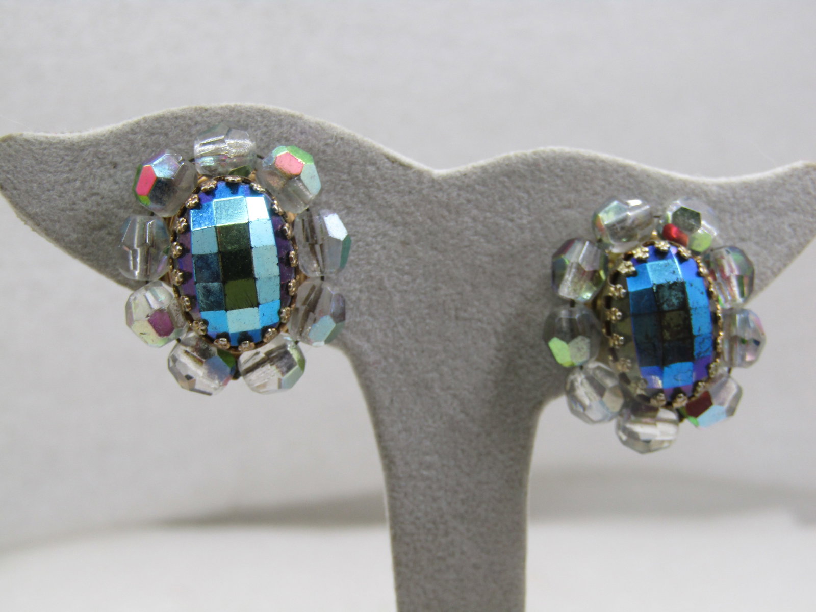 Vintage Peacock Aurora Borealis Clip Earrings, 1940's: Vintage Peacock Aurora Borealis Clip Earrings, 1940's. 1" by 3/4" ovals with a center honeycomb faceted peacock bezel-set crown prong aurora borealis stone that is appx. 16mm by 10mm oval. Around