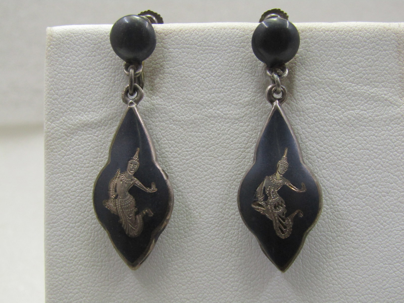 Vintage Sterling Siam Goddess Black Goddess Earrings, Screw Back: Vintage Sterling Siam Goddess Black Goddess Earrings, Screw Back. 8mm black enameled stud with a dangling puffy black enameled and sterling etched Siam Goddess drop. The drop is appx. 1.25" long and 5