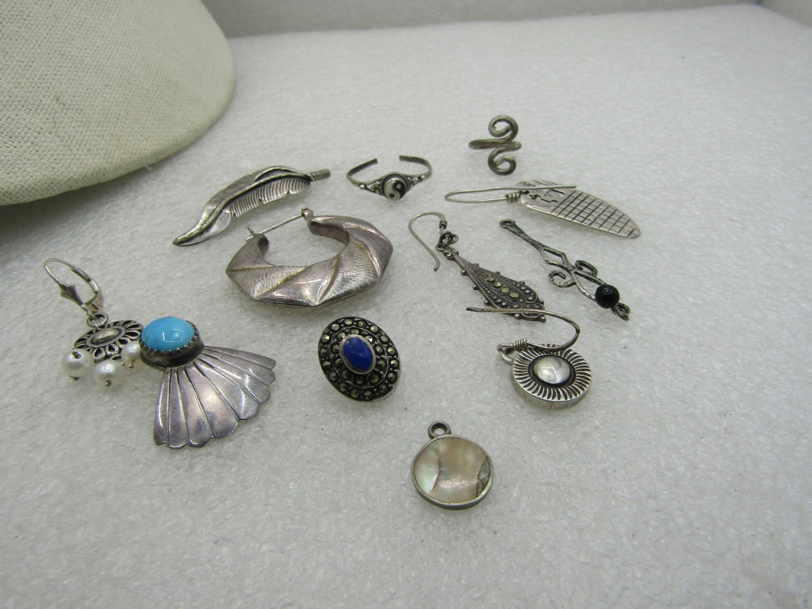 12 Sterling Pieces, Single Earrings, Dangles, more. 25.49 grams: 12 Sterling Pieces, Single Earrings, Dangles, more. 25.49 grams, 7 single earrings, turquoise southwestern, southwestern, drop, sunlike drop, faux pearl dangle leverbck, lapis lazuli marcasite stud , 