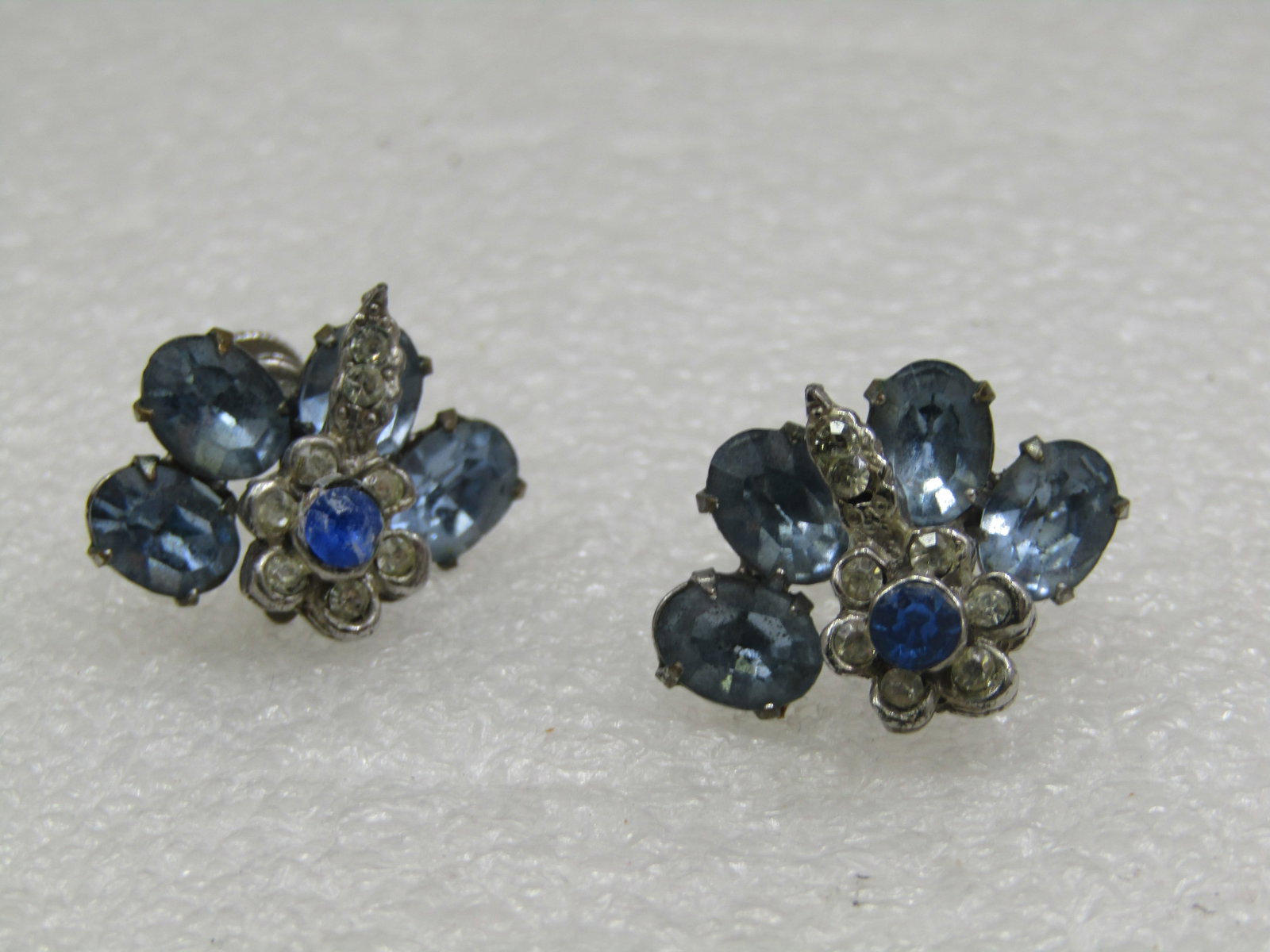 Vintage Art Deco Rhinestone & Floral Earrings, Screwback, 1930's-1940's: Vintage Art Deco Rhinestone & Floral Earrings, Screwback, 1930's-1940's. Silver tone metal with blue oval rhinestones, four - set in a curved design at the top of the earrings - each stone is appx. 7.