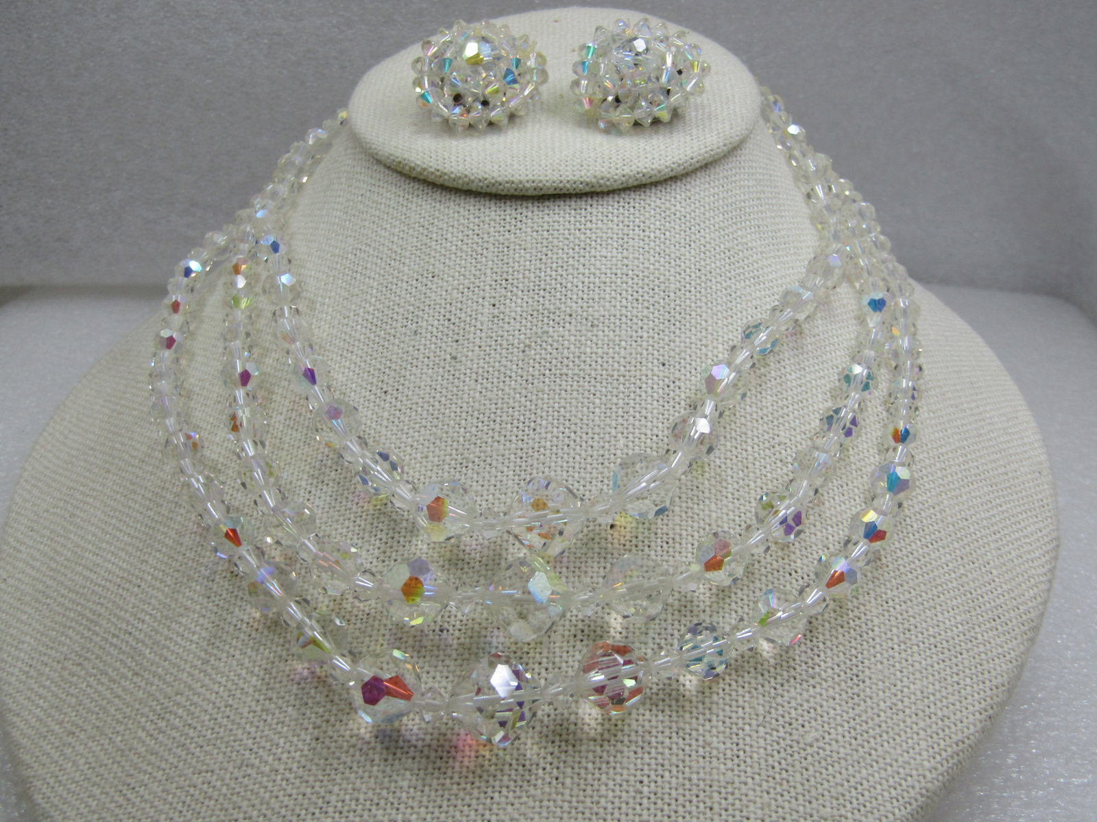 Vintage Crystal Aurora Borealis Beaded Necklace & Clip Earrings Set, 16": Vintage Crystal Aurora Borealis Beaded Necklace & Clip Earrings Set, 16". The beads are clear and sparkling and in very good condition with shimmer. Triple strands of graduated beads that range from